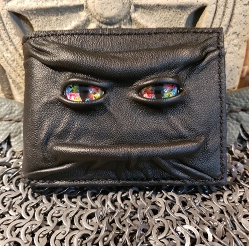 A mystical face and eyes on a wallet